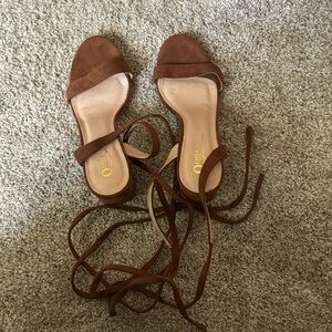 Brown suede, lace-up sandals.